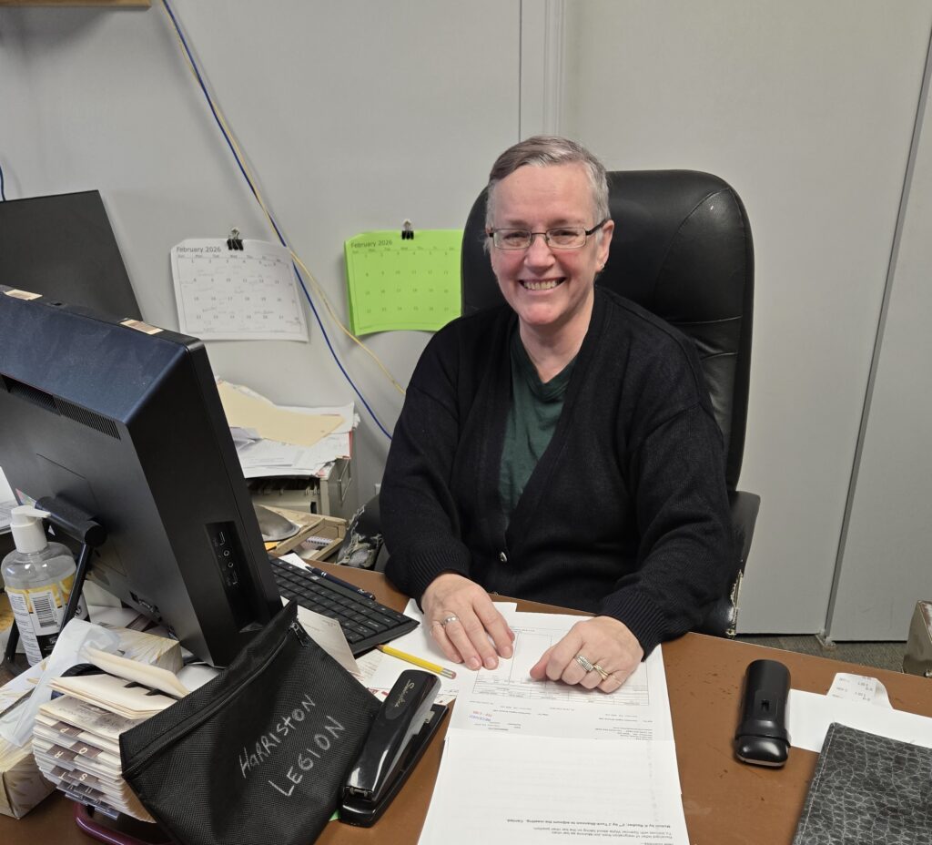 Photo of office administrator Flo Van Meer at her desk.